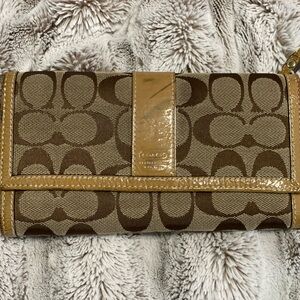 Well loved Coach wallet with checkbook cover.